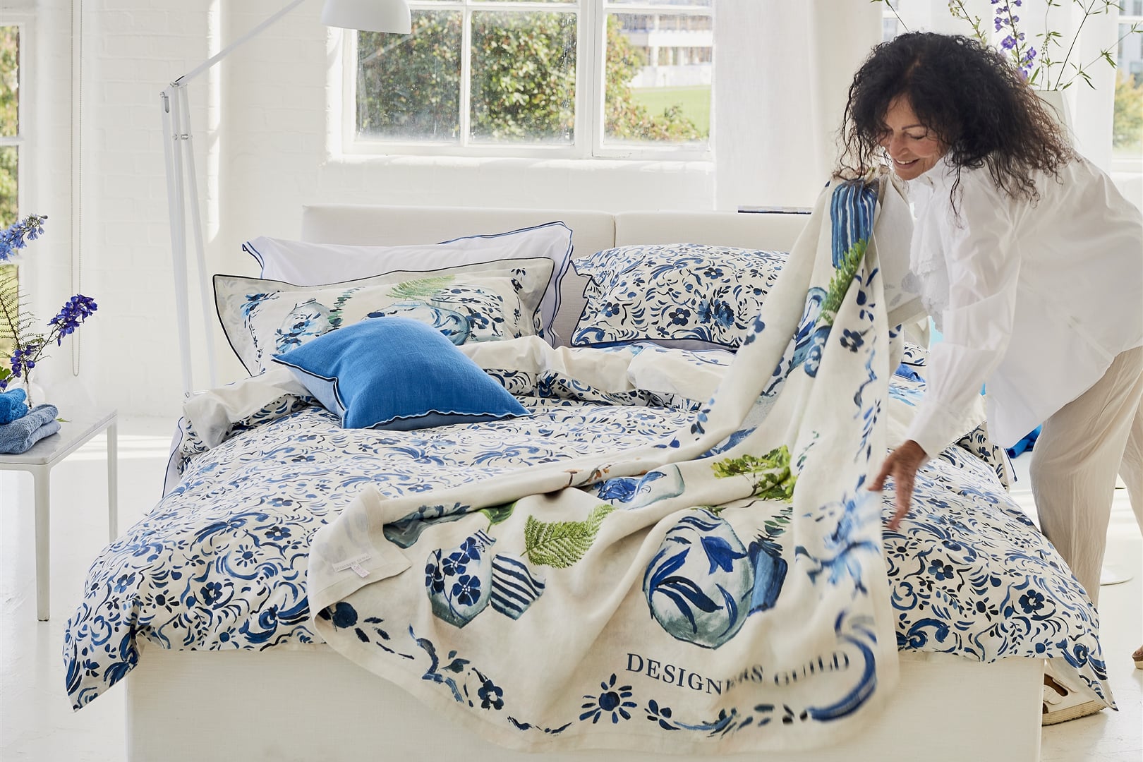 Floral throw styled on a sofa or bed for a fresh decorative interior