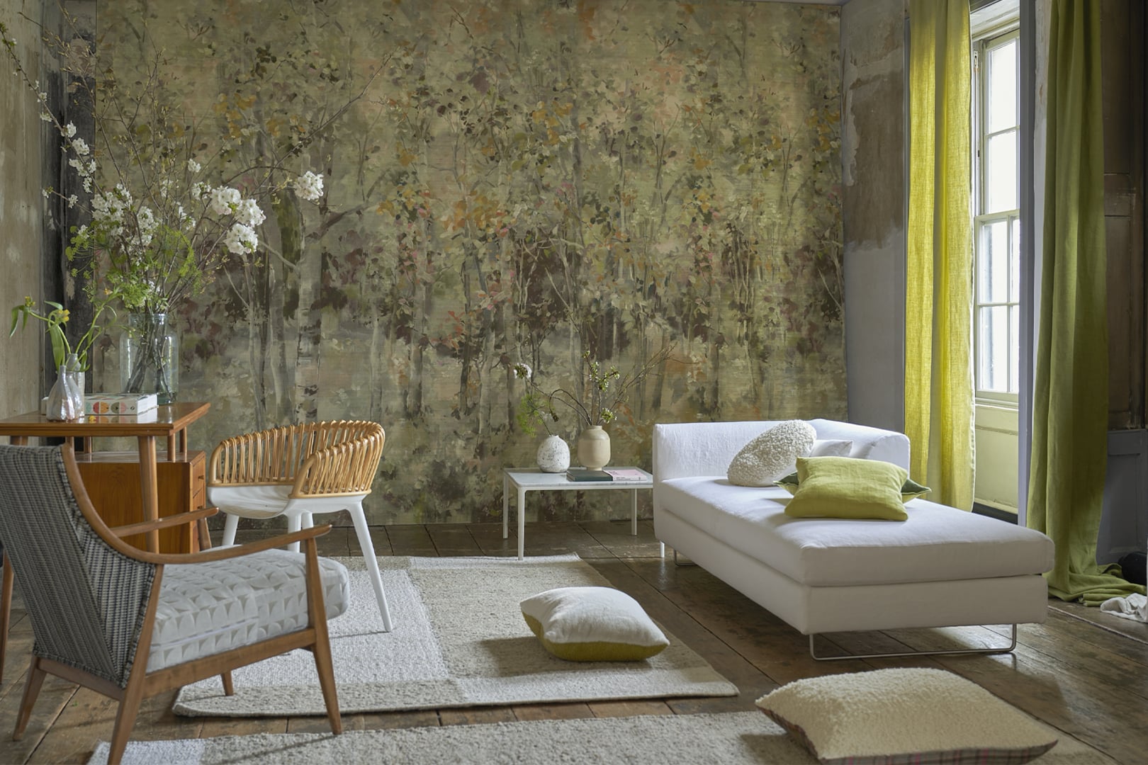 Light neutral rug styled in a bright living room with sofa, cushions and fresh green accents