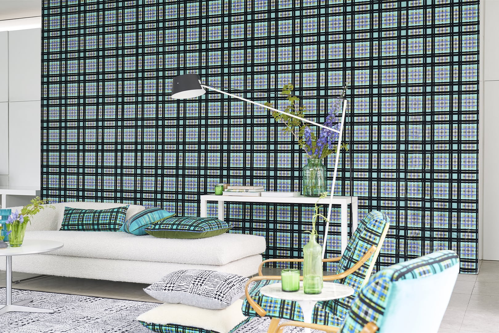 Interior detail with blue and green checked wallpaper and flowers on a table