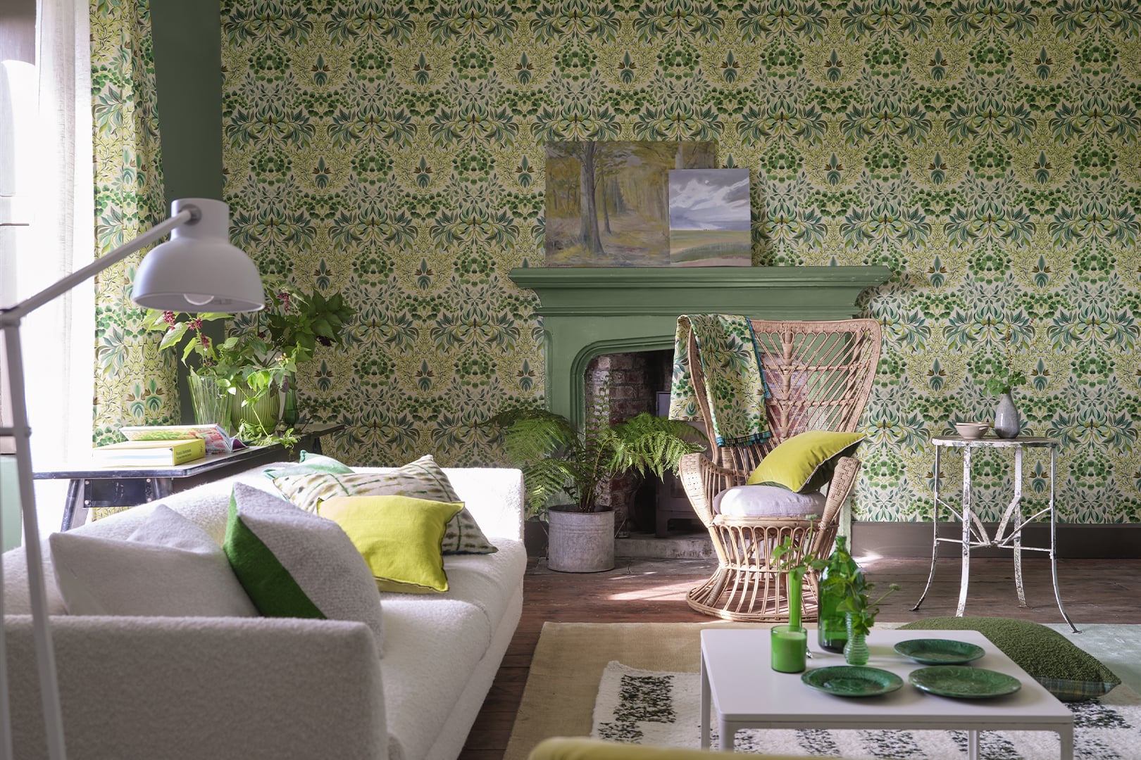 Living room with green damask wallpaper, patterned sofa and layered green accessories